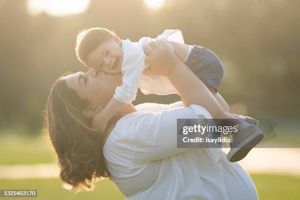 a little boy with down syndrome is smiling - down syndrome baby stockfoto's en -beelden