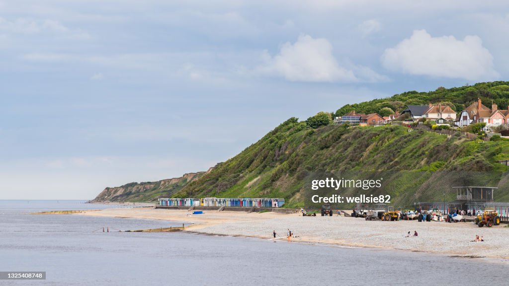 Beach huts sandwiched between the sea and cliffs at Cromer