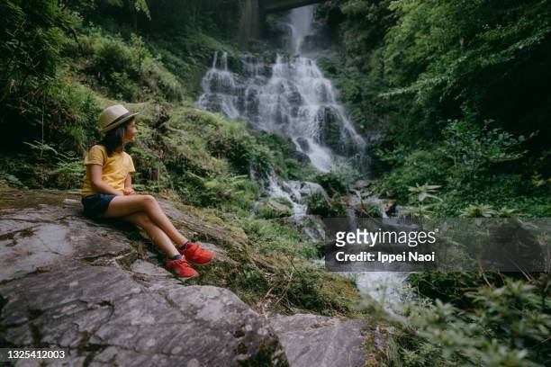 young girl in forest with waterfall, japan - präfektur kochi stock-fotos und bilder