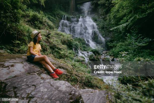 young girl in forest with waterfall, japan - präfektur kochi stock-fotos und bilder
