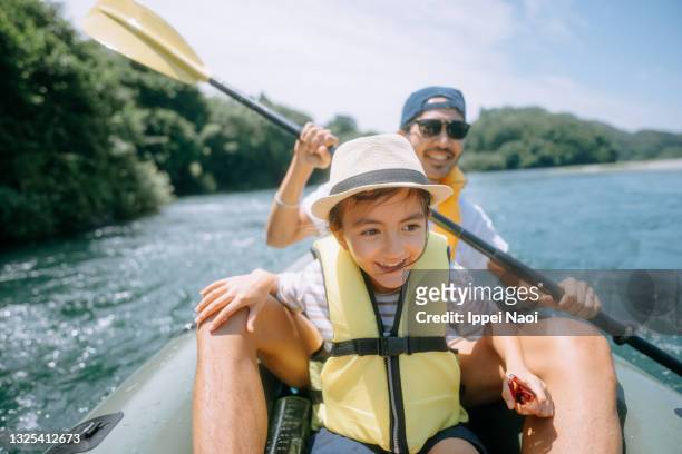 young girl and her father enjoying river kayaking, japan - kayak stock pictures, royalty-free photos & images