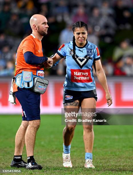Tiana Penitani of New South Wales looks dejected as she is taken from the field injured during the Women's Rugby League State of Origin match at the...