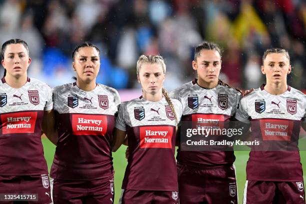 The Queensland players embrace during the playing of the national anthem before the Women's Rugby League State of Origin match at the Sunshine Coast...