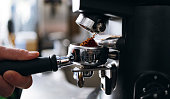 Professional Grinding Freshly Roasted Coffee in a Espresso Machine