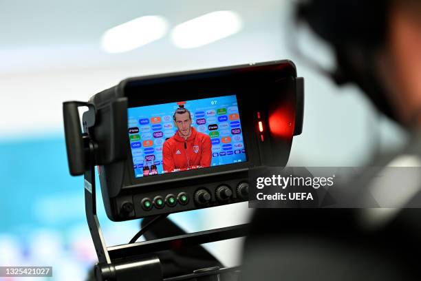 In this handout picture provided by UEFA, A monitor on a TV Camera is seen filming as Gareth Bale of Wales speaks to media during the Wales Press...