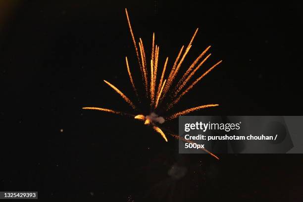 low angle view of firework display at night - silvesterfeuerwerk stock-fotos und bilder
