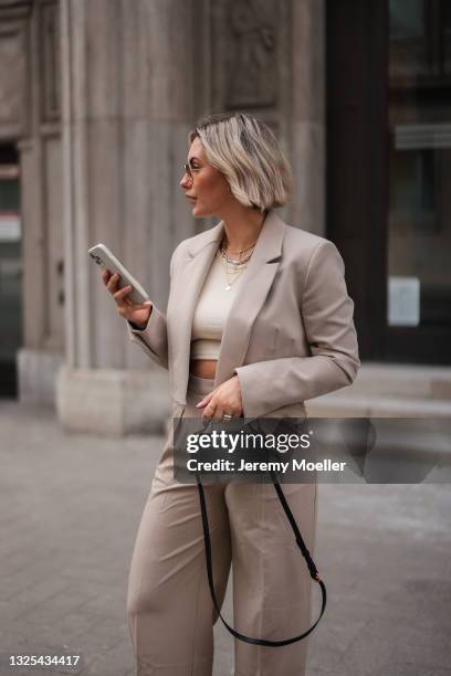 Franzi Koenig wearing light brown Zara blazer, light brown NAKD pants, black Jacquemus mini leather bag and Fafe Collection jewelry poses on June 18,...