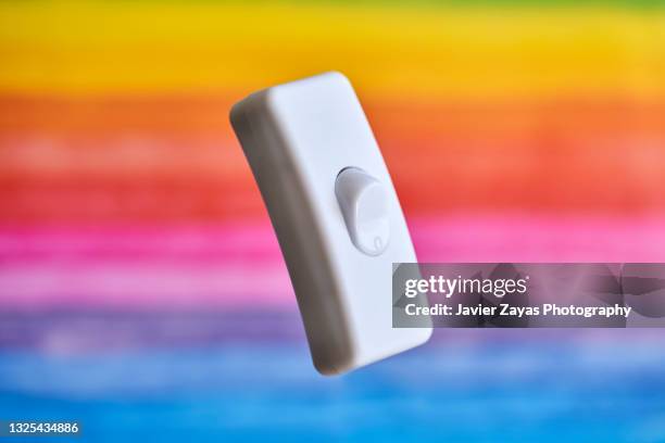 light switch on multicolored background - toggle switch stock pictures, royalty-free photos & images