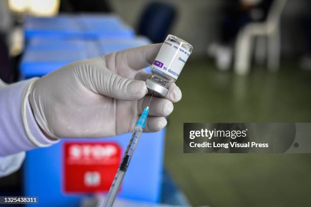 Nurse takes a shot from the AstraZeneca COVID-19 Vaccine to apply it to a patient at the border city of Ipiales located in the department of Narino...