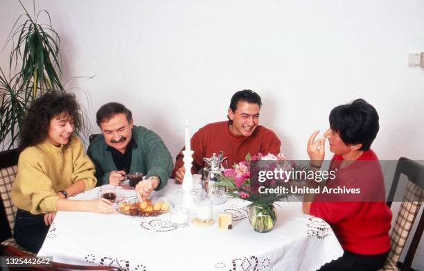 Maria Ketikidou, deutsche Schauspielerin, mit ihrer Familie am Tisch zu Hause in Hamburg, Deutschland 1990.