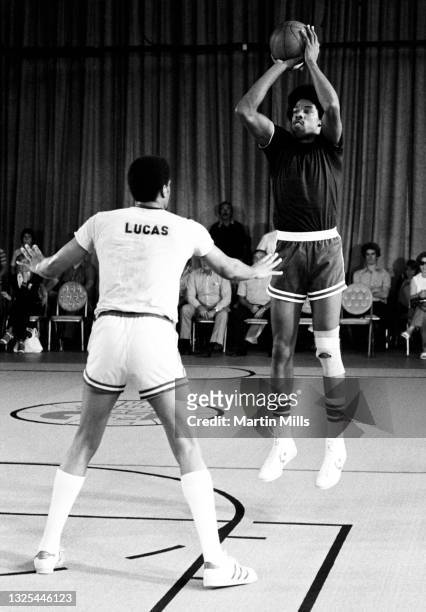 Player of the Philadelphia 76ers Julius Erving shoots over NBA player of the Portland Trail Blazers Maurice Lucas during the 3 on 3 Celebrity...
