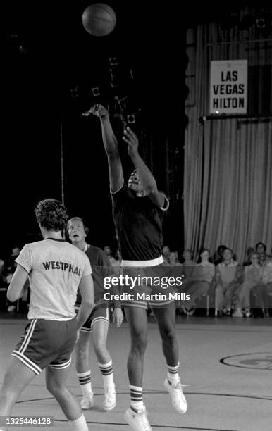 Player of the Denver Nuggets David Thompson shoots over NBA player of the Phoenix Suns Paul Westphal , as American singer, composer, actor, writer,...