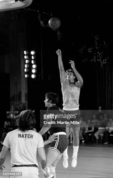 Player of the Phoenix Suns Paul Westphal shoots over former NBA player Jerry Lucas as American actor Richard Hatch looks on during the 3 on 3...