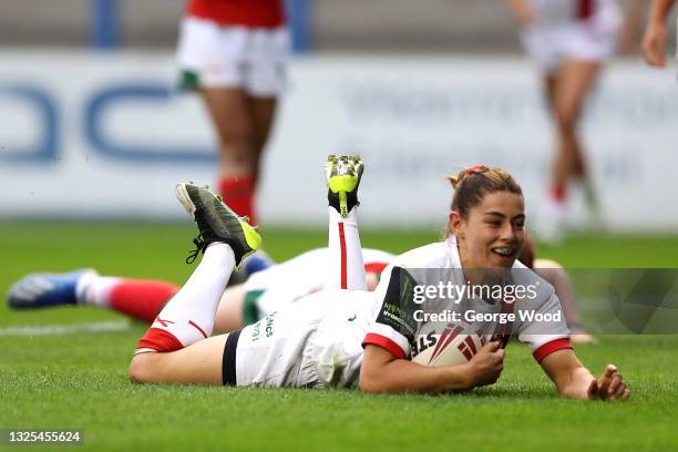 Vicky Molyneux of England scores a try during the Rugby League International match between England Women and Wales Women at The Halliwell Jones...