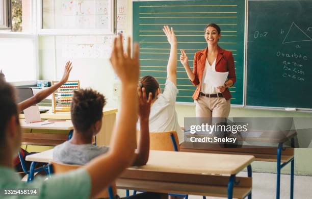 everybody in class raised hands. - asking time stock pictures, royalty-free photos & images