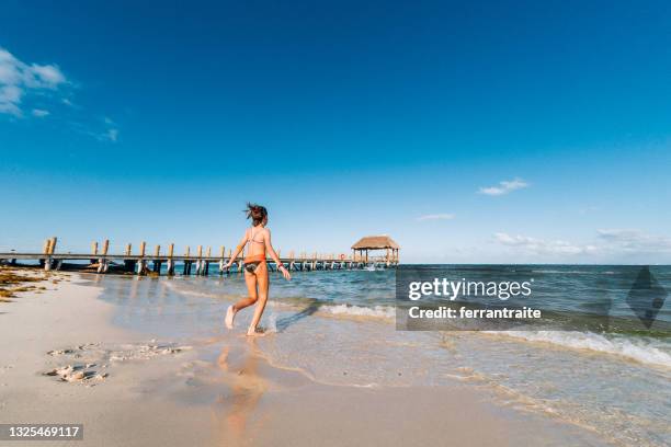 little girl running to the water in cancun - cancun stock pictures, royalty-free photos & images