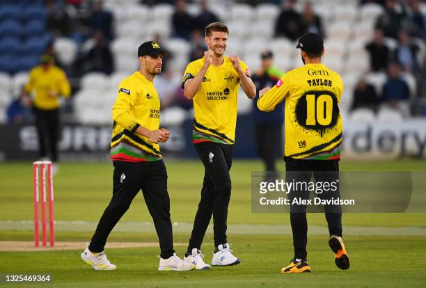 David Payne of Gloucestershire celebrates taking the wicket of Travis Head of Sussex with Benny Howell and Jack Taylor during the Vitality T20 Blast...