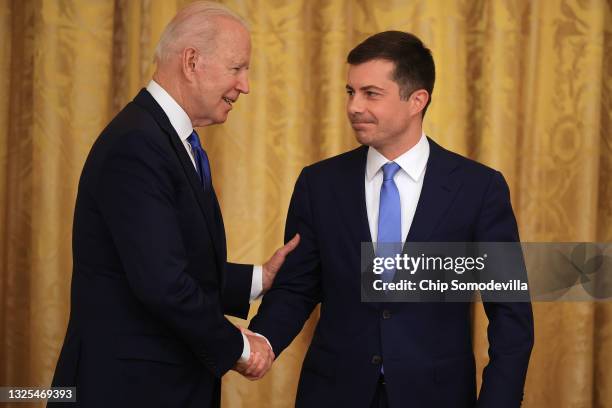 President Joe Biden shakes hands with Transportation Secretary Pete Buttigieg during an event commemorating LGBTQ+ Pride Month at the White House on...