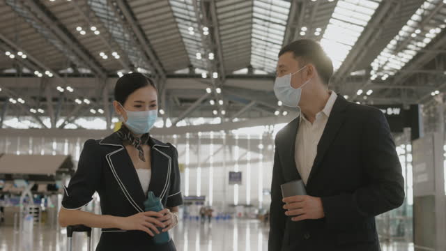Two vaccinated flight attendant chat on the way to their duty - stock video