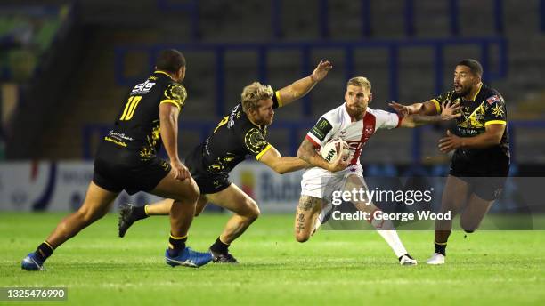 Sam Tomkins of England looks to break away from Matt Prior and Kruise Leeming of Combined Nations All Stars during the Rugby League International...