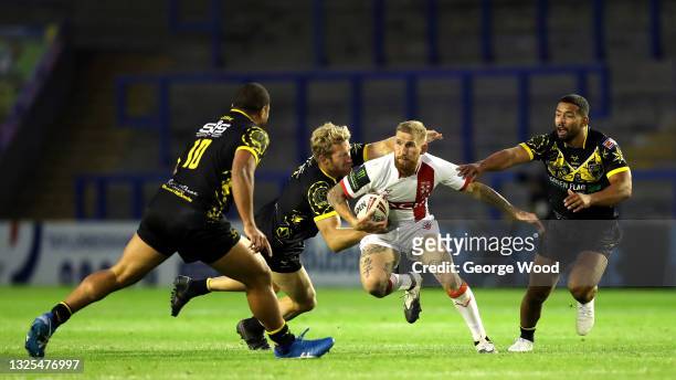 Sam Tomkins of England looks to break away from Matt Prior and Kruise Leeming of Combined Nations All Stars during the Rugby League International...