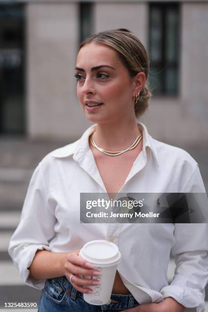 Lynn Frangenberg wearing white Ralph Lauren shirt, Zara ripped blue jeans and Fafe Collection jewelry on June 18, 2021 in Cologne, Germany.