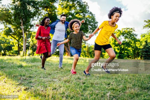 family chasing each other - tag 11 stock pictures, royalty-free photos & images