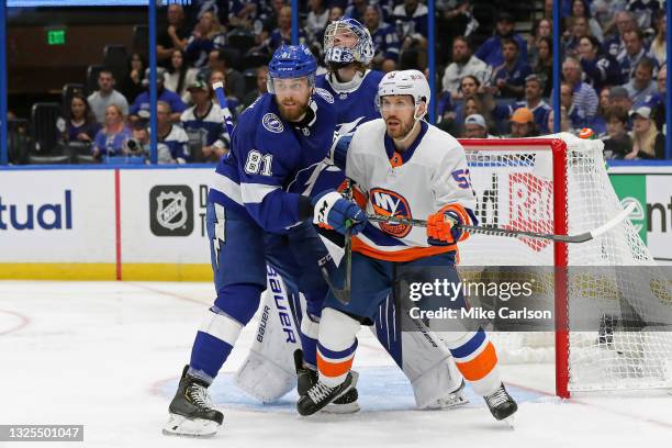 Erik Cernak of the Tampa Bay Lightning and Casey Cizikas of the New York Islanders battle for position in front of Andrei Vasilevskiy during the...