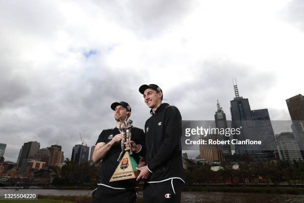 Mitch McCarron and Mason Peatling of Melbourne United pose with the NBL Championship Trophy during a Melbourne United NBL media opportunity after...