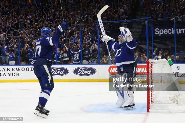 Victor Hedman and Andrei Vasilevskiy of the Tampa Bay Lightning celebrate the team's 1-0 win against the New York Islanders in Game Seven of the NHL...