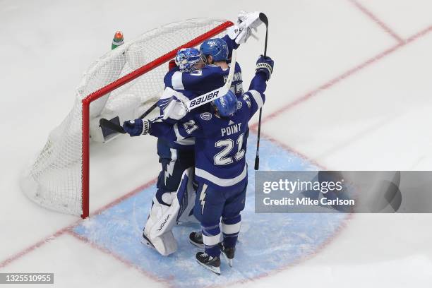 Andrei Vasilevskiy, Brayden Point and Victor Hedman of the Tampa Bay Lightning celebrate after defeating the New York Islanders 1-0 in Game Seven of...