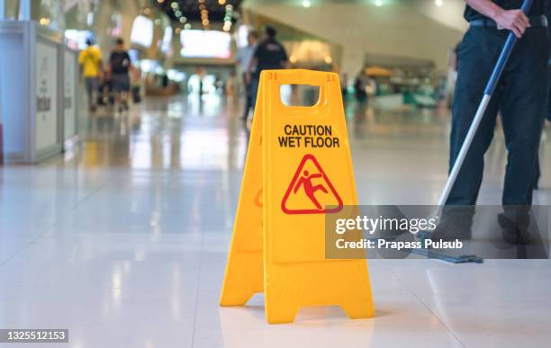 wet floor caution sign on floor - office cleaning bildbanksfoton och bilder