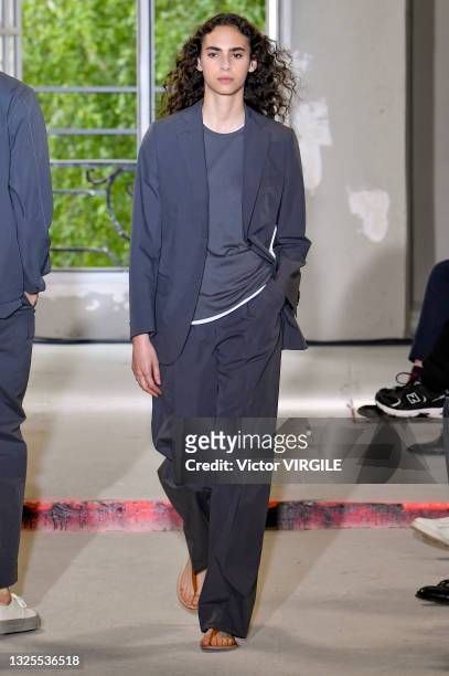 Model walks the runway during the Officine Generale Ready to Wear Spring/Summer 2022 fashion show as part of the Paris Men Fashion Week on June 25,...