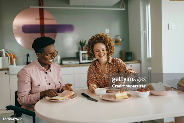 two girlfriends enjoying breakfast - spreading stock pictures, royalty-free photos & images