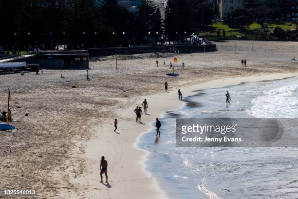 People are seen at Coogee Beach on June 26, 2021 in Sydney, Australia. Residents who live or work in the four local government areas of Woollahra,...