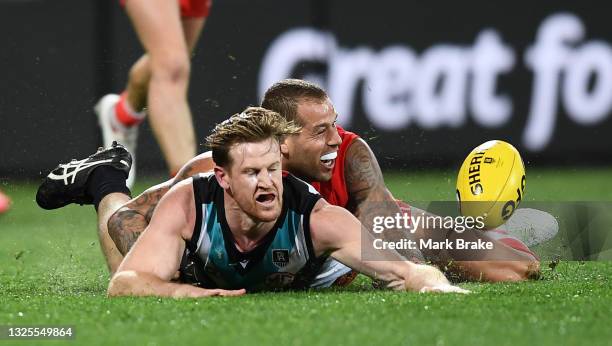 Lance Franklin of the Swans tackles Tom Jonas of Port Adelaide during the round 15 AFL match between the Port Adelaide Power and the Sydney Swans at...