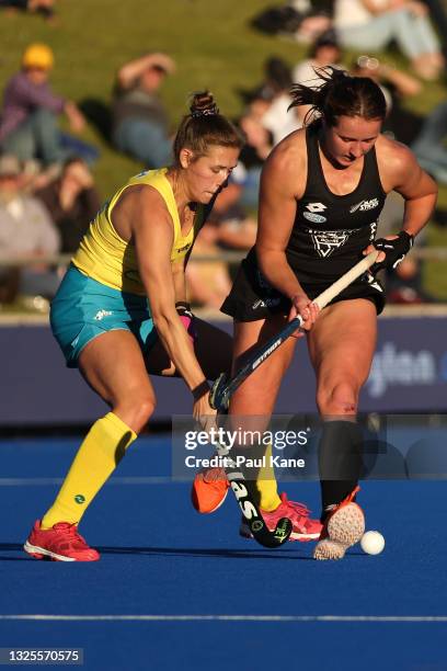 Kaitlin Nobbs of the Hockeyroos and Olivia Shannon of the Black Sticks contest for the ball during the FIH Pro League match between the Australian...