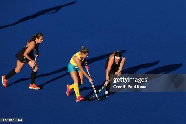 Kaitlin Nobbs of the Hockeyroos is challenged by Tessa Jopp of the Black Sticks during the FIH Pro League match between the Australian Hockeyroos and...