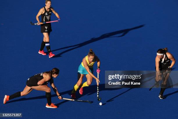 Kaitlin Nobbs of the Hockeyroos is challenged by Olivia Shannon of the Black Sticks during the FIH Pro League match between the Australian Hockeyroos...