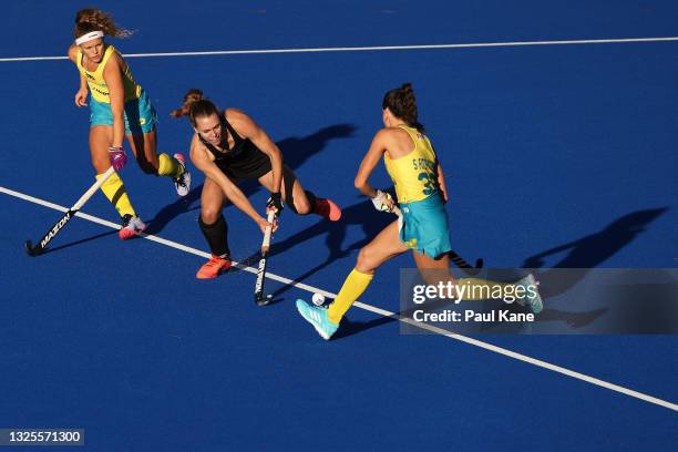 Frances Davies of the Black Sticks is challenged by Rosie Malone and Savannah Fitzpatrick of the Hockeyroos during the FIH Pro League match between...