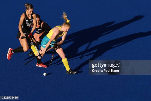 Amy Lawton of the Hockeyroos is challenged by Rose Keddell of the Black Sticks during the FIH Pro League match between the Australian Hockeyroos and...
