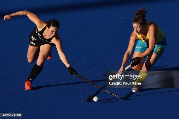 Kate Jenner of the Hockeyroos is challenged by Kelsey Smith of the Black Sticks during the FIH Pro League match between the Australian Hockeyroos and...
