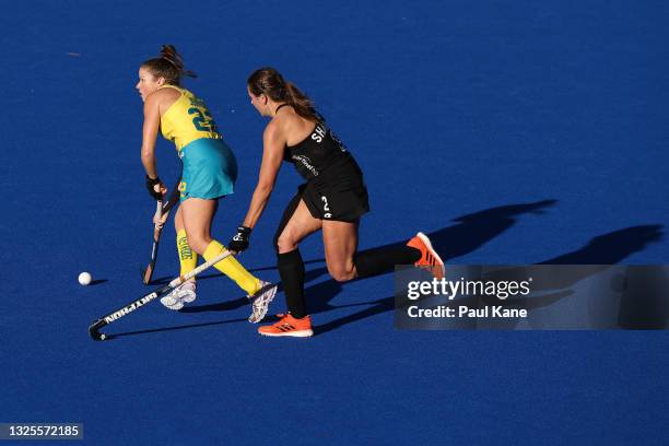Kate Jenner of the Hockeyroos controls the ball against Olivia Shannon of the Black Sticks during the FIH Pro League match between the Australian...
