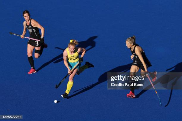 Amy Lawton of the Hockeyroos controls the ball against Samantha Charlton and Stacey Michelsen of the Black Sticks during the FIH Pro League match...