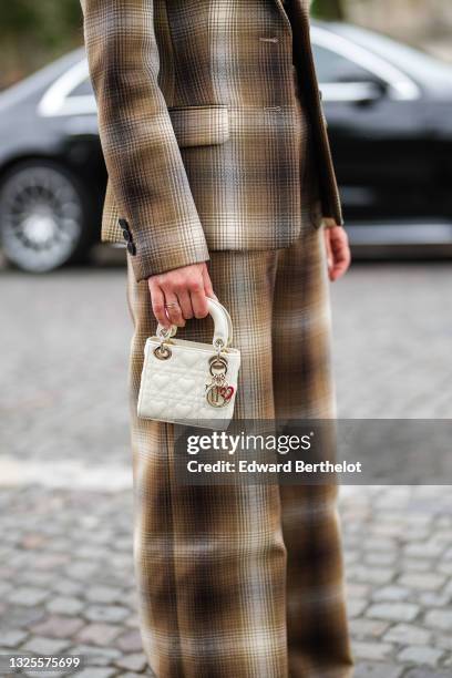 Alice Barbier wears a brown and beige checkered blazer jacket, matching brown and beige checkered large pants, a white latte matte leather small Lady...