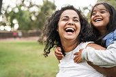 Happy indian mother having fun with her daughter outdoor - Family and love concept - Focus on mum face