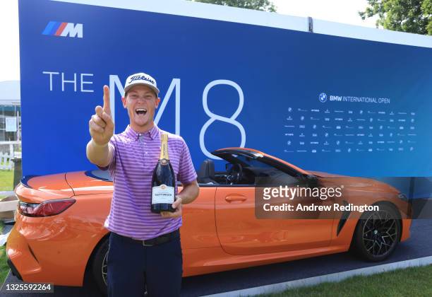 Vincent Norrman of Sweden is presented with a bottle of champagne after making a hole-in-one albatross on the 16th hole during Day Three of The BMW...