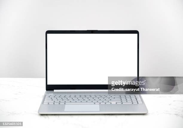 computer white screen notebook sits on a white desk white background - desktop pc ストックフォトと画像