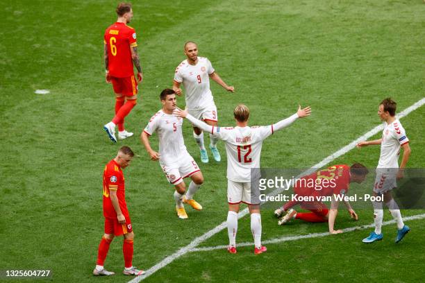 Kasper Dolberg of Denmark celebrates with Joakim Maehle, Martin Braithwaite and Mikkel Damsgaard after scoring their side's first goal during the...