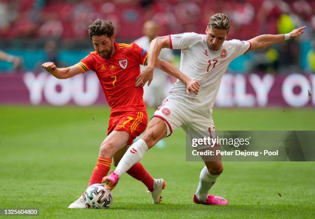 Joe Allen of Wales battles for possession with Jens Stryger Larsen of Denmark during the UEFA Euro 2020 Championship Round of 16 match between Wales...